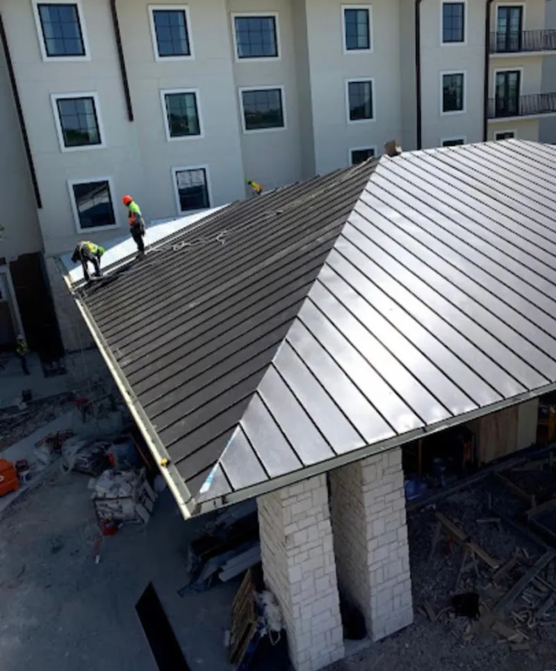 Crew installing standing seam metal roof panels on a commercial project in Gardnerville Ranchos